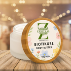 Biotikure body butter container with floral design on a wooden surface