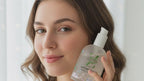 Woman holding a bottle of facial cleanser -Natural body care product